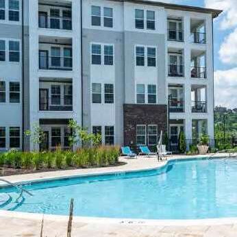 Apartment complex with a pool outside