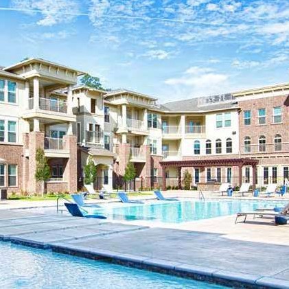 Apartment complex surround a pool outside